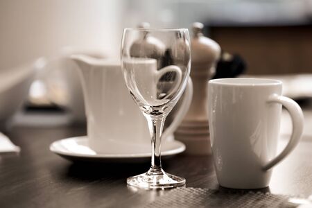 Wine glass and coffee cup on breakfast tableの写真素材