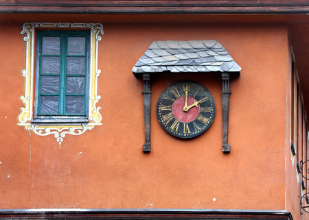 Old wall clock on the exterior of buildingの写真素材