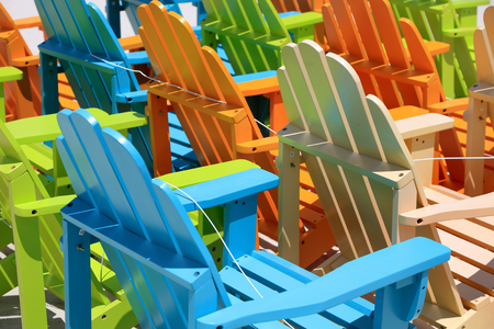 Colorful beach chairs arranged in rows.の写真素材