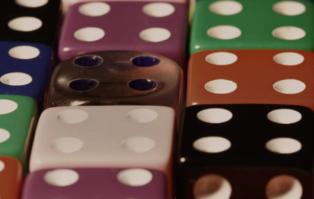 Red,blue and green dice on black background