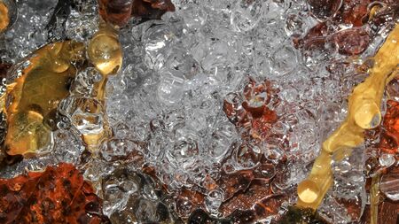 Ice formation on dried leaves abstract backgroundの写真素材