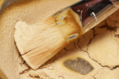 Paint brush in dry paint bowlの写真素材