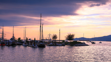 Vancouver, British Columbia, CANADA - July 01 , 2019-Maritime museum ferry dock under sunset,Ferries...