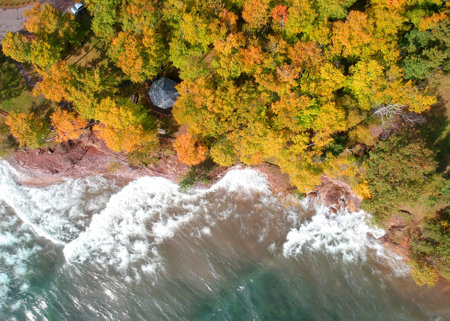 Aerial view of lake superior shore with autumn trees in Michigan upper peninsulaの写真素材