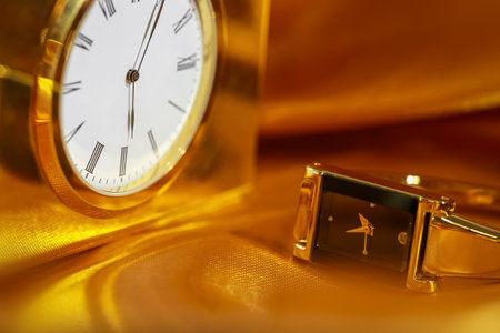 Close up shot of golden watch and clock