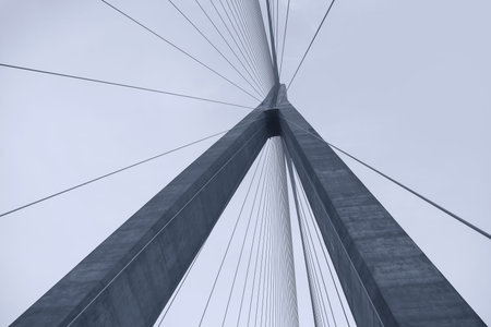 Tall suspension bridge view from bottomの写真素材