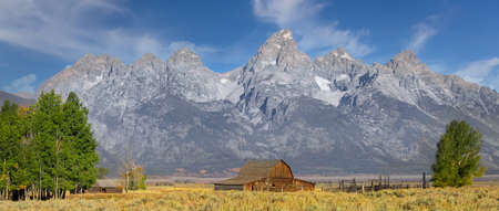 Historic Mormon barn in front of Teton mountain range in Grand Teton national park.の写真素材