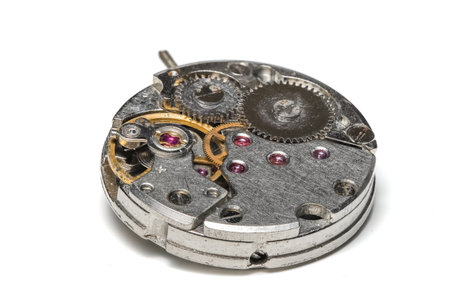 Old watch mechanism on white backgroundの写真素材