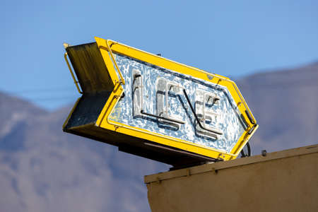 Old weathered yellow sign board with letters Ice.の写真素材