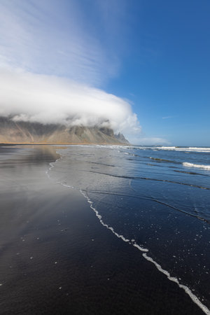 Vestrahorn mountain with cloud cover in Iceland, view from beachの写真素材