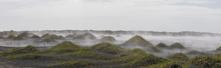 Panoramic view of fog covered black sand beach at Vestrahorn, Iceland.の写真素材