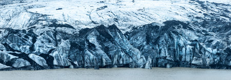 Panoramic view of huge Svinafellsjokull glacier in southern Iceland with cloud cover.の写真素材