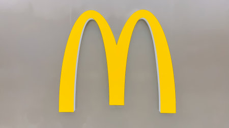 Detroit, Michigan - December 27, 2022 : Mc Donald's logo on a wall inside North terminal of Detroit airport. McDonald's is the world's largest chain of hamburger fast food restaurants.のeditorial素材