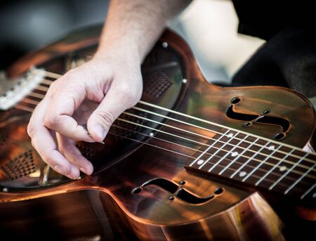 Hands playing guitar in a diagonal positionの写真素材