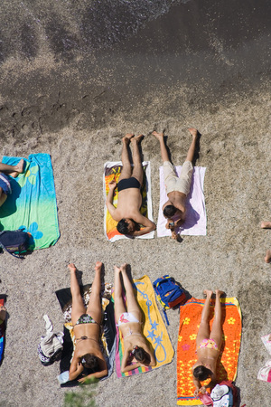 A crowded beach in Sorrento,Italy. Boys and girls sunbathing. Top view.の写真素材
