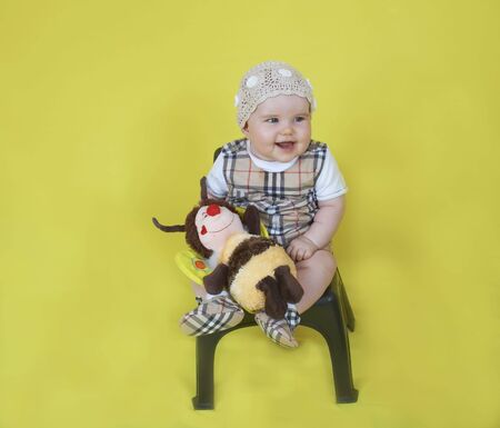 Cute baby sit and smile with a toyの写真素材