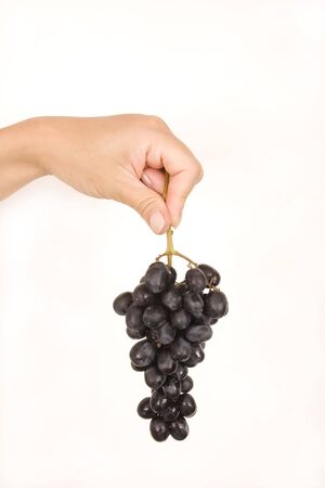 Fruit, grapes in a women hand, isolated, white backgroundの写真素材