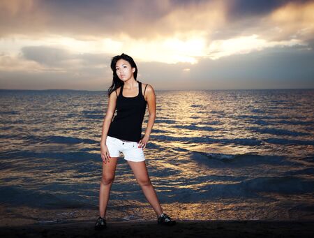 Cute asian girl stay on the beachの写真素材