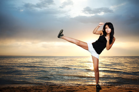Cute asian girl stay on the beach and kickの写真素材