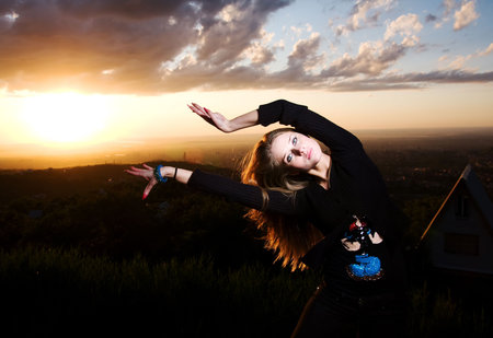 Beuaty european girl dances on a sunset
