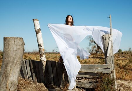 The bared girl model poses under a white veilの写真素材