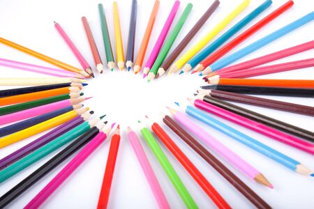 Colour pencils laid out in the form of heartの写真素材