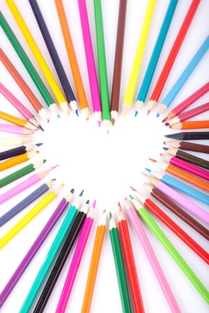 Colour pencils laid out in the form of heartの写真素材