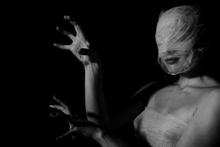 The bared girl wound with bandage emotional portraits on a black backgroundの写真素材