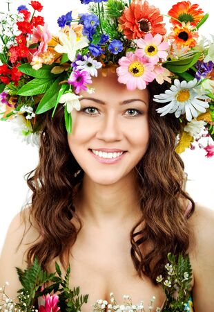 The attractive girl, front portrait, on a head a flower wreathの写真素材