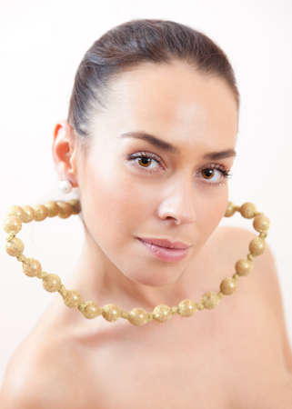 Portrait of the beautiful girl with a groundless beadsの写真素材