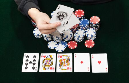 Heap poker chips and higher card combination in poker game  flush royaleのeditorial素材