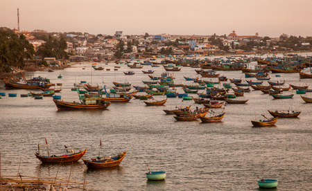 A lot of boats at sunset in the bay, a fishing villageの写真素材