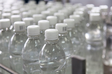Bottle filled with water standing on the assembly line