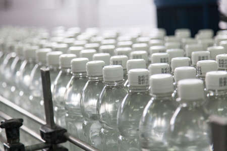 Bottle filled with water standing on the assembly lineの写真素材