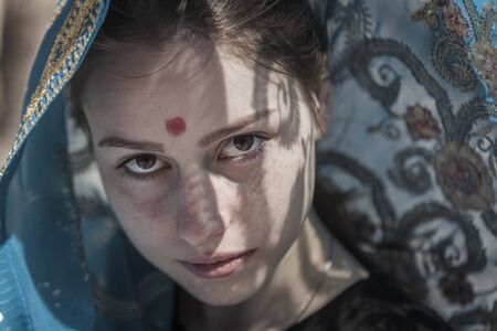 The girl the European covered with a sari, a faces portraitの写真素材