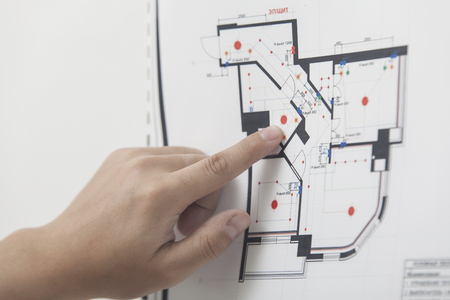 The architect studies the drawing of the new apartmentの写真素材