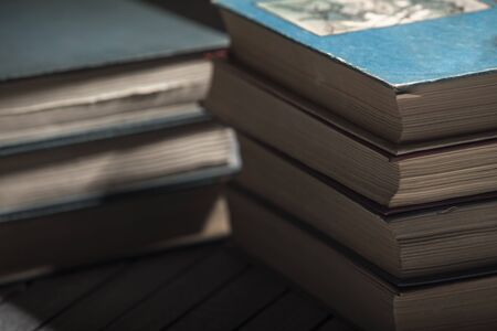 The pile of books lies on a table, a background, other pile, knowledge, libraryの写真素材