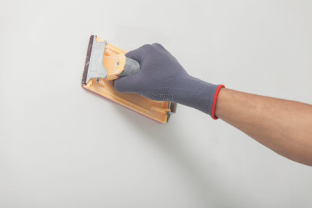 The repairman levels walls after whitewashingの写真素材