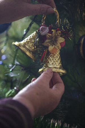 Hands of older woman decorating Christmas treeの写真素材