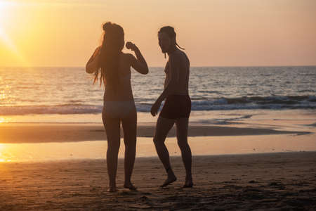Silhouette of a young couple together at the beach, Goa, Indiaの写真素材