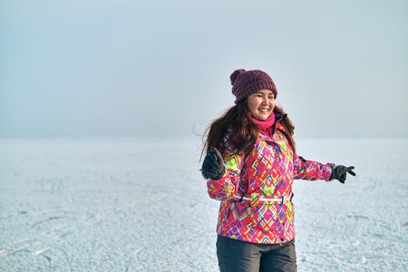Winter outdoor activities, woman ice skating on a frozen lake