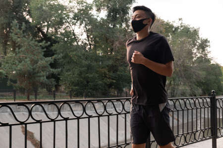 An Asian man running in the city, in the evening. Kazakhstanの写真素材