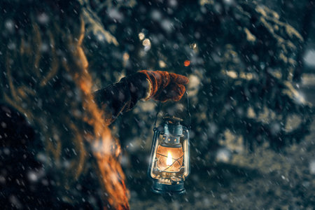 Young girl with lantern in winter forest fairy tale, book cover, christmas time, closeupの写真素材