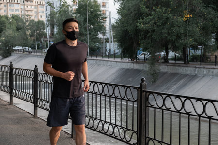 An Asian man running in the city, in the evening. Kazakhstanの写真素材