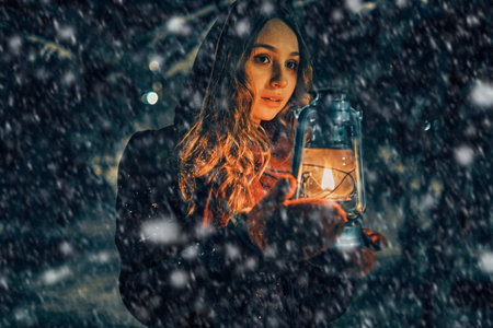Young girl with lantern in winter forest fairy tale, book cover, christmas timeの写真素材