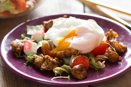 Salad with chicken and poached eggの写真素材