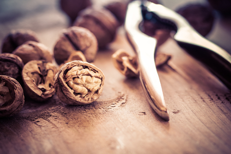 Walnuts on a wooden table in retro style.の写真素材