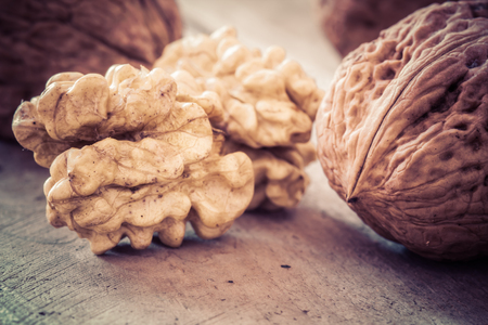 Walnuts on a wooden table in retro style.の写真素材