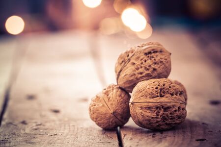 Walnuts on an old wooden table. Christmas background.の写真素材