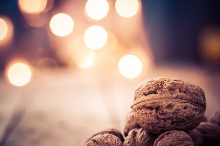 Walnuts on an old wooden table. Christmas background.の写真素材